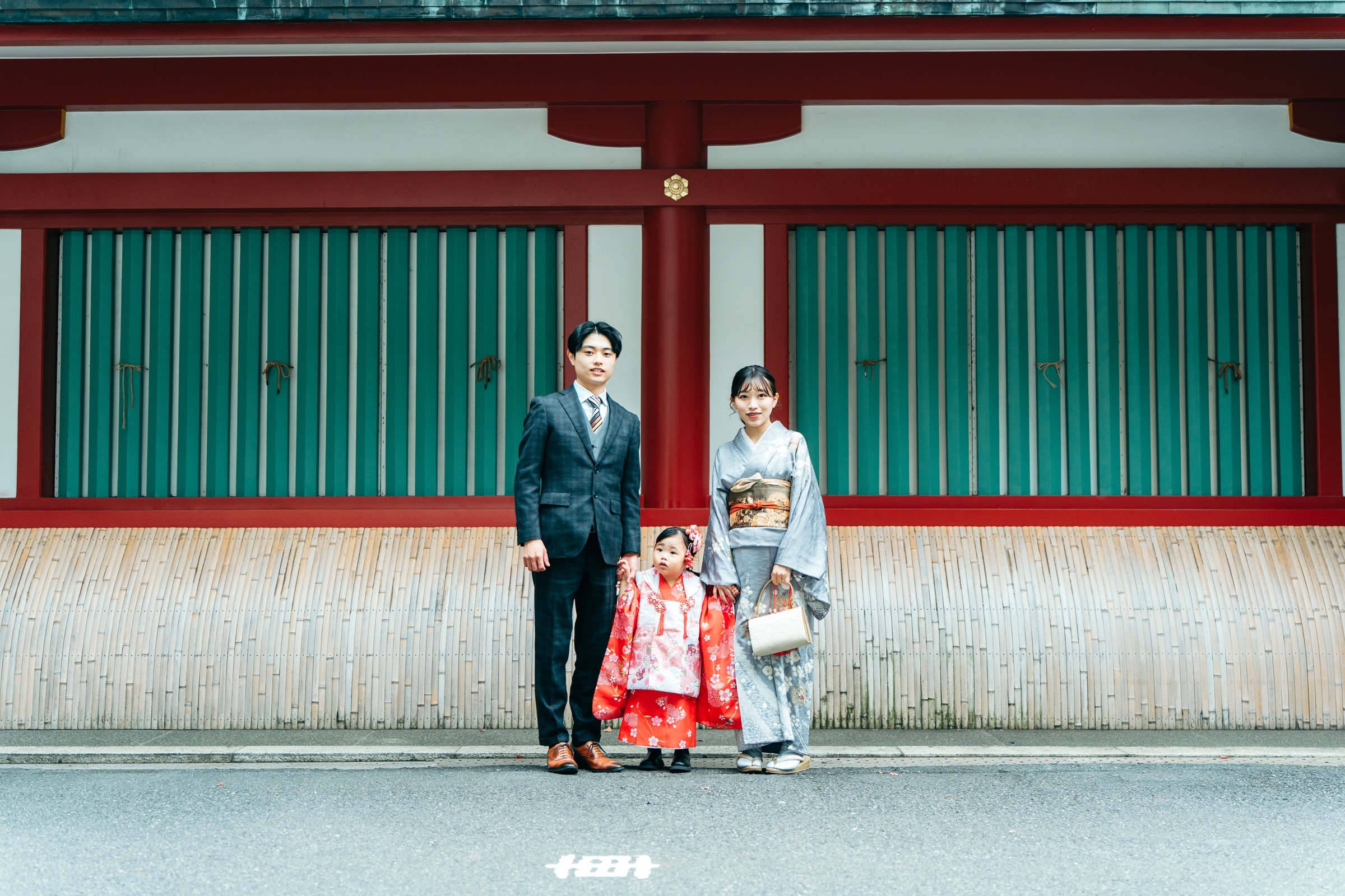 日枝神社 本殿の壁を背景にした家族写真